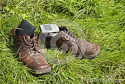 Funny picture -dirty old shoes over green grass Stock Photo