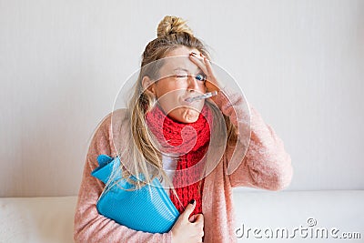 Funny picture of sick woman measuring temperature with thermometer in her mouth Stock Photo