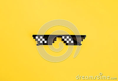 Funny pixelated boss sunglasses on yellow background. Gangster, Black thug life meme glasses . Pixel 8bit style Stock Photo