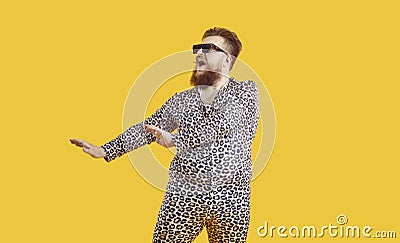 Funny plus size man in sunglasses and leopard PJs dancing and singing in fashion studio Stock Photo