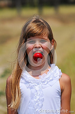 Funny portrait with apple in mouth Stock Photo