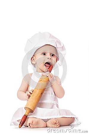 Funny portrait infant cook baby portrait wearing apron and chef hat with dough rolling pin, isolated on a white background Stock Photo