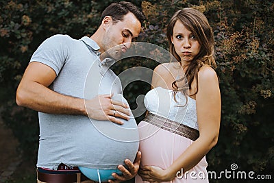 Funny portrait of pregnant wife and pregnant husband Stock Photo