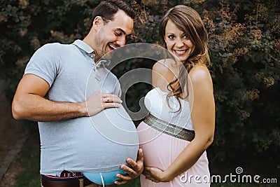 Funny portrait of pregnant wife and pregnant husband Stock Photo