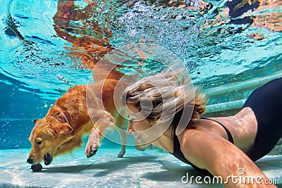 Funny portrait of smiley woman with dog in swimming pool Stock Photo