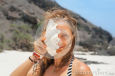 Funny portrait of young woman with sea shell Stock Photo