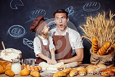 Playful man with daughter making bread Stock Photo