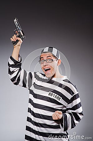 Funny prisoner with firearm on gray Stock Photo