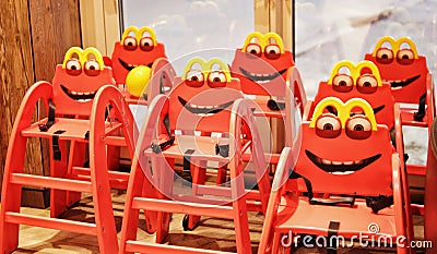 Funny red children`s chairs in a cafe Editorial Stock Photo