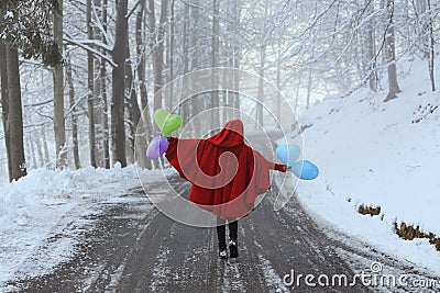 Funny red hooded woman with colorful balloons Stock Photo