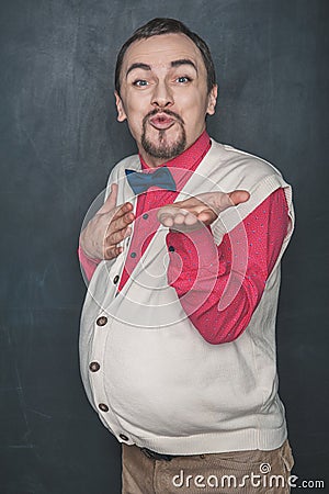 Funny romantic man vintage style sending kiss on blackboard Stock Photo