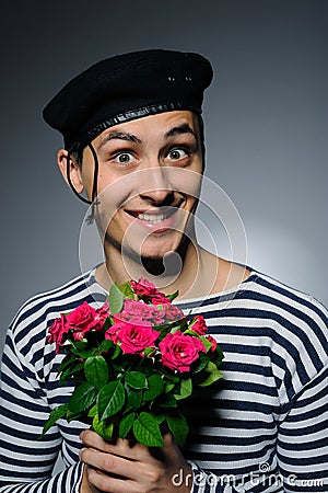 Funny romantic sailor man holding rose flowers Stock Photo