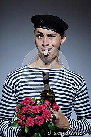 Funny romantic sailor man opening bottle Stock Photo