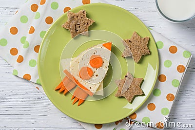Funny sandwich with cheese and carrots in a shape of rocket and stars, meal for kids idea Stock Photo