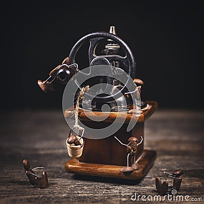 Funny scene with coffee bean figueres and a coffee mill or grinder Stock Photo