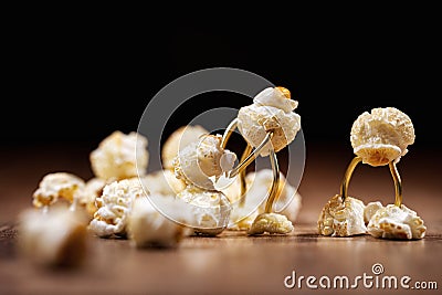 Funny scene with popcorn figures on a wooden table Stock Photo