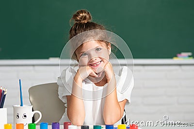 Funny school girl face. Child girl drawing with coloring pens paintind. Portrait of adorable little girl smiling happily Stock Photo