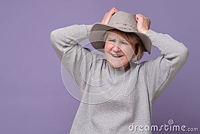 Funny senior caucasian woman remembered something and holds a hand on head Stock Photo