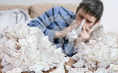 Funny sick man who has flu or cold is blowing his nose. Stock Photo