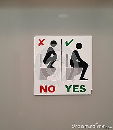 Funny sign on a toilet stall in Cologne, Germany Editorial Stock Photo