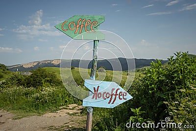 Funny signpost on a mountain road near a small cafe Stock Photo