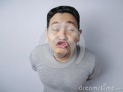 Funny Silly Asian Man Trying to Kiss Stock Photo