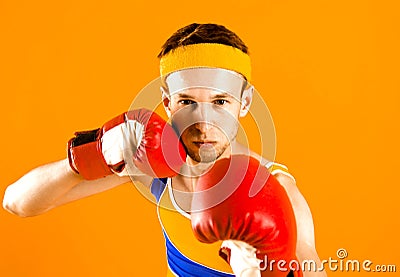 Funny skinny boxer man with red boxing gloves. Stock Photo