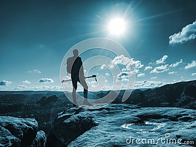 Funny slim tourist guy with backpack holds trekking stick Stock Photo