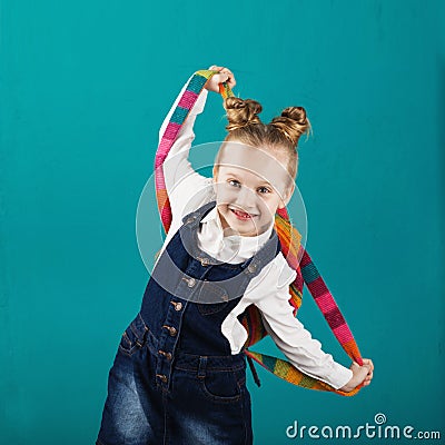 Funny smiling little girl with big backpack jumping and having f Stock Photo