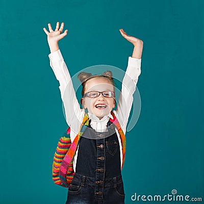 Funny smiling little girl with big backpack jumping and having f Stock Photo