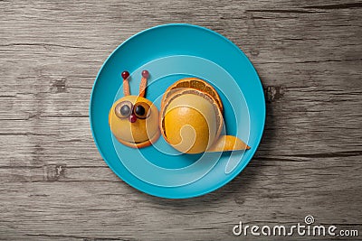 Funny snail made of juicy fruits Stock Photo