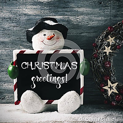 Snowman and text christmas greetings Stock Photo