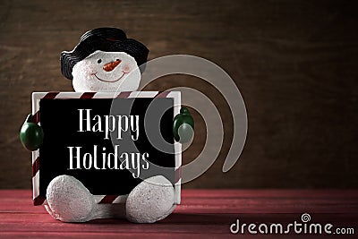 Snowman and text happy holidays Stock Photo
