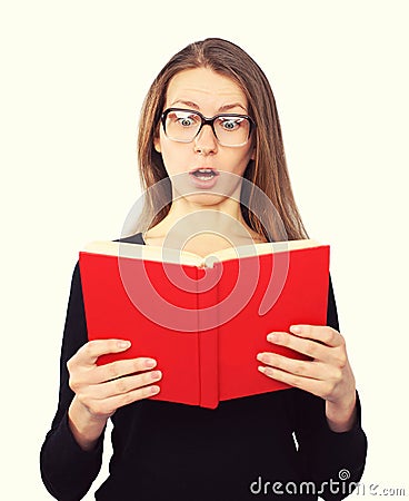 Funny student girl in glasses shocked looking in the book Stock Photo