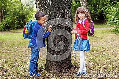 Funny students go to school. Children play in the park. The concept is back to school. Stock Photo