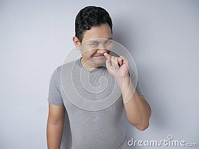Funny Stupid Man Picking Nose While Smiling to Camera Stock Photo