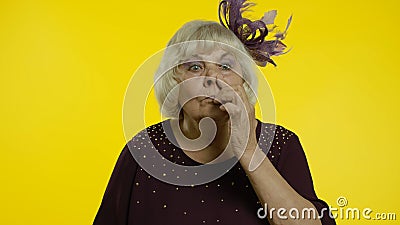 Funny stupid senior old woman picking nose with silly expression, removing boogers, bad manners Stock Photo