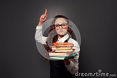 Funny teacher in glasses with pile of textbooks Stock Photo