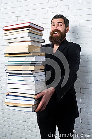 Funny teacher or professor with book stack. Thinking serious mature teacher. Falling books concept. Mature professor Stock Photo