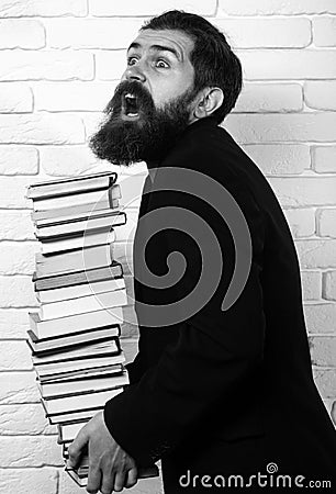 Funny teacher or professor with book stack. Thinking serious mature teacher. Falling books concept. Mature professor Stock Photo