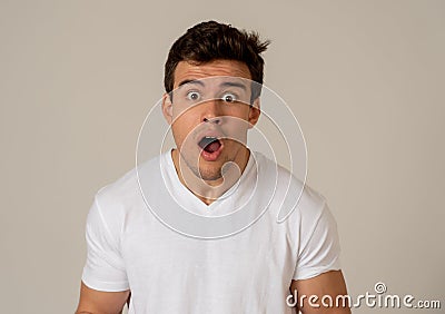 Funny teenager surprised and happy pointing at something great and unbelievable Stock Photo