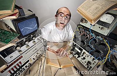 Funny timid scientist reading book Stock Photo