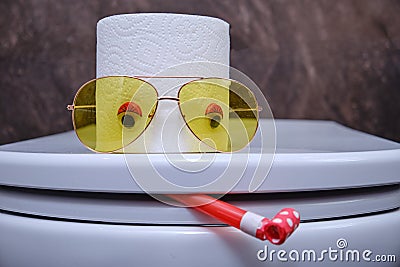 Funny toilet paper and toilet bowl with eyes in glasses Stock Photo