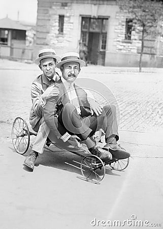 Funny Vintage Men Playing, Riding Go Cart Stock Photo