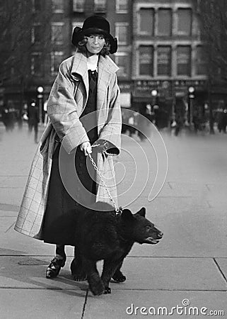 Funny Vintage Woman Walking Bear in City Stock Photo