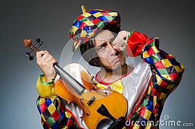 The funny violin clown player in musical concept Stock Photo