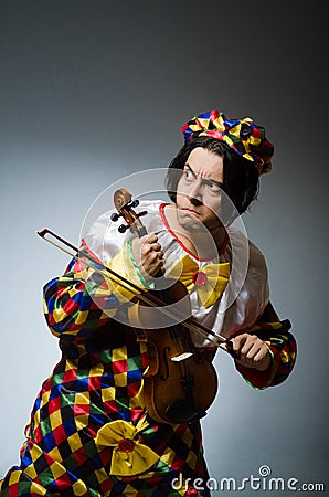 Funny violin clown player in musical concept Stock Photo