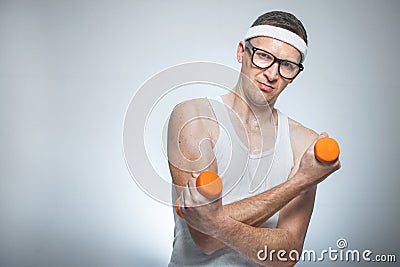 Funny weak man lifting biceps Stock Photo