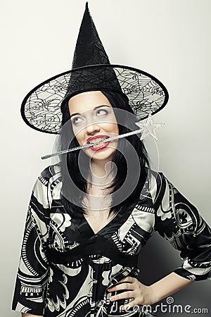 Funny Witch. Young happy woman with canival hat. Stock Photo