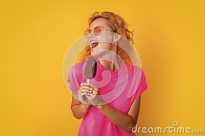 funny woman with icelolly ice cream isolated on yellow. woman with icelolly ice cream Stock Photo